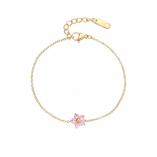 Georgiana Beauty Boutique gold-tone chain bracelet featuring a delicate pink crystal flower charm and adjustable clasp.