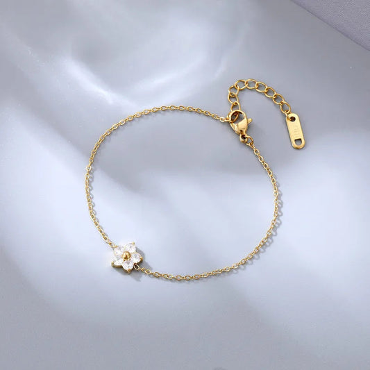 Georgiana Beauty Boutique delicate gold-tone chain bracelet featuring a crystal-encrusted flower charm.